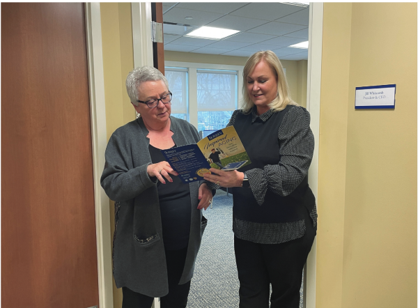 Serving seniors:  Conestoga alumna and CEO of Surrey Services, Jill Whitcomb (right), shows a member at Surrey the services it offers seniors to improve their quality of life. Former Wayne resident Jeanne LaRouche founded the nonprofit in 1981 after witnessing her elderly neighbors struggle to remain independent. 